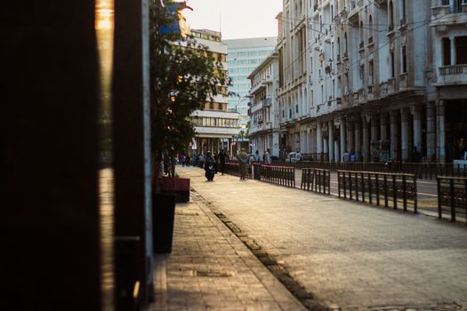 Charming street scene in Casablanca, Morocco during sunset, showcasing architecture and daily life.