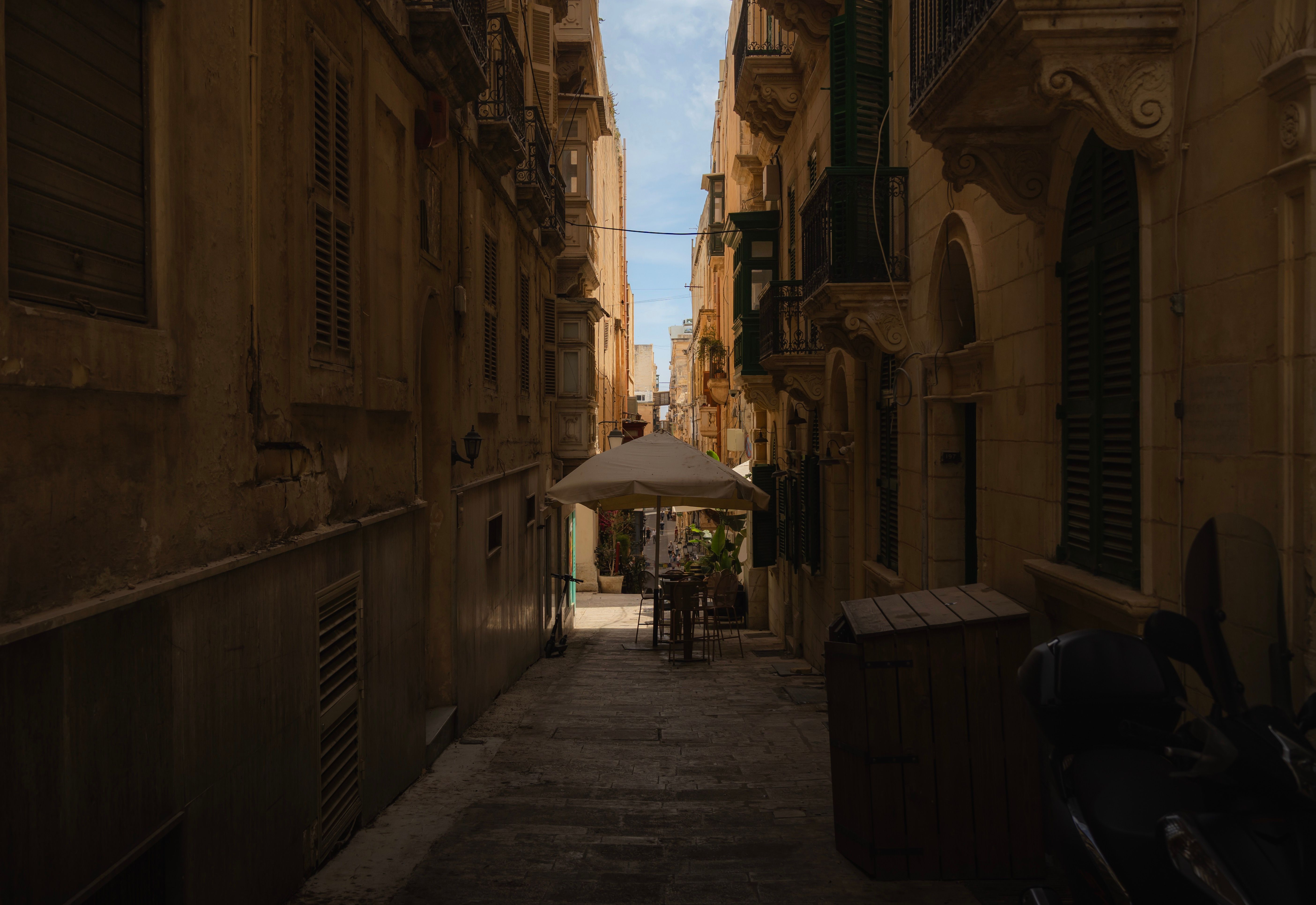Tourists walking through a bustling street in Valletta, Malta, with attention to personal belongings