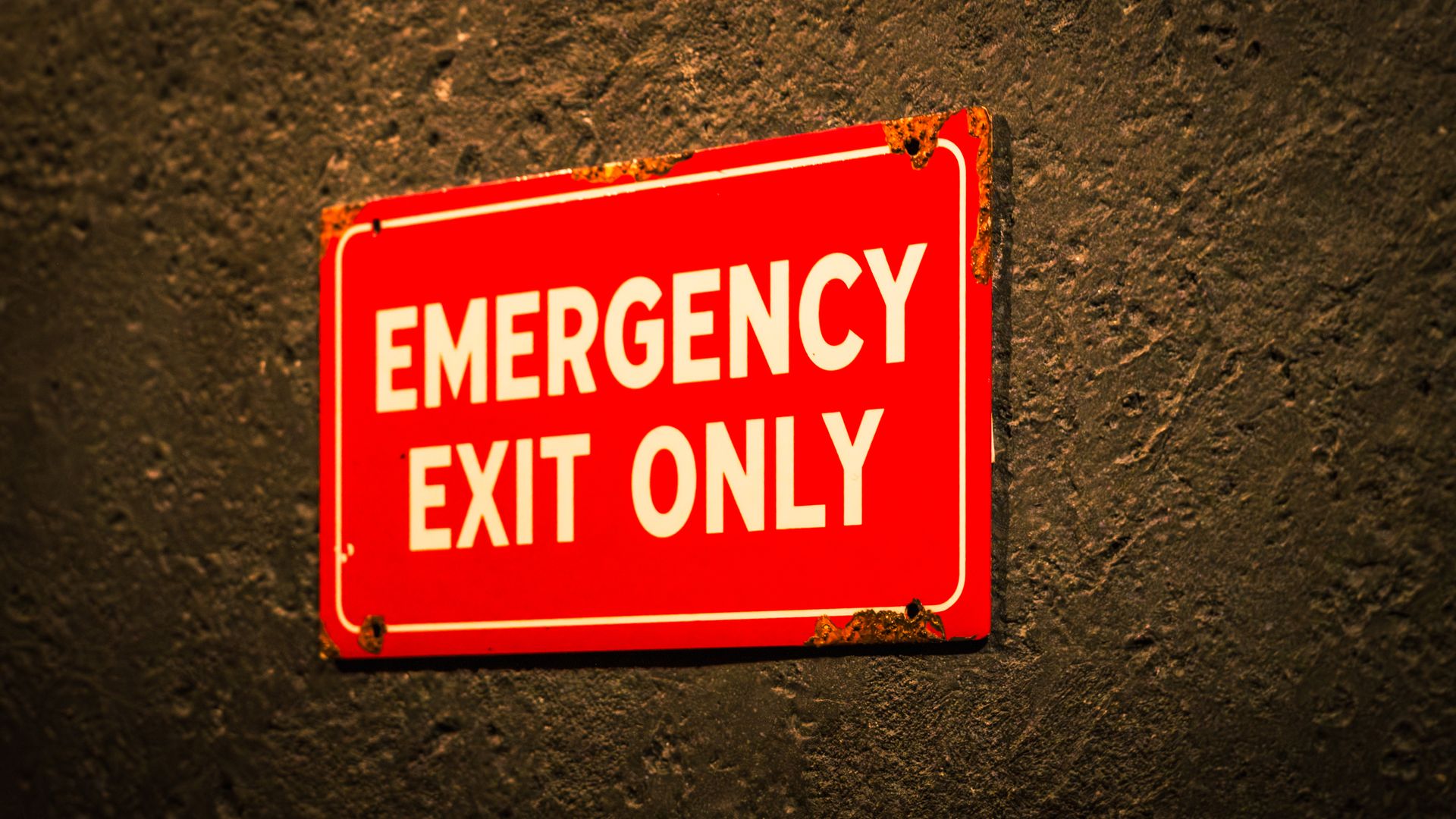 Modafinil Skin Rash Warning Signs: What to Look For A vintage-style emergency exit sign on a textured wall, emphasizing safety and industrial themes — modafinil skin rash warning signs