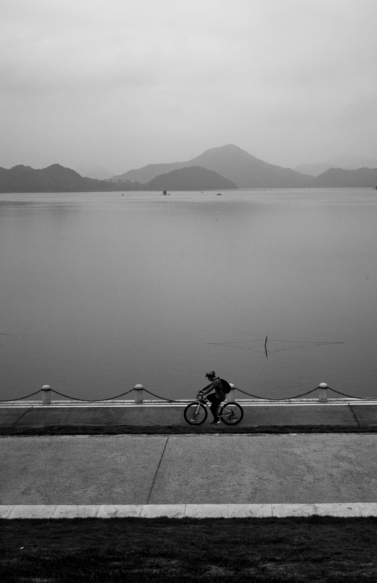 Cyclist riding along the paved lakeside cycling path at Sun Moon Lake