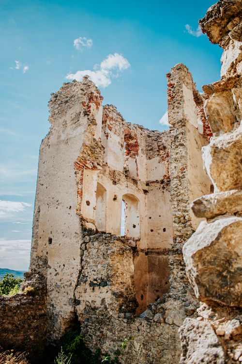 Free A captivating view of historic stone ruins against a vivid blue sky, showcasing architectural history. Stock Photo