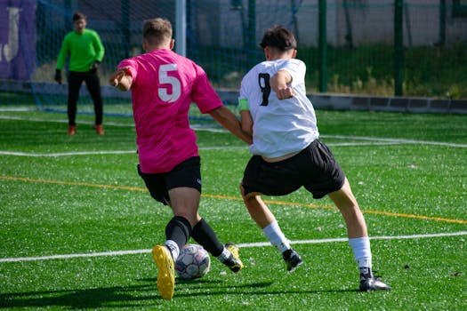 Action-packed soccer match with players competing on a bright, sunny day.