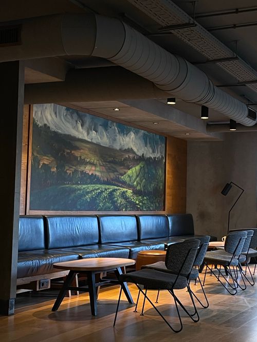Free Stylish cafe in Valencia featuring modern seating and scenic wall art for a unique ambiance. Stock Photo