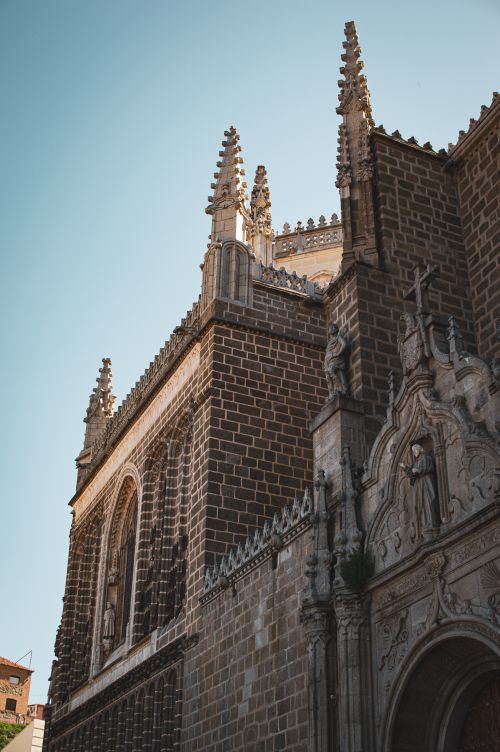 Free Ornate Gothic facade of a historic church in Toledo, Spain under clear blue sky. Stock Photo