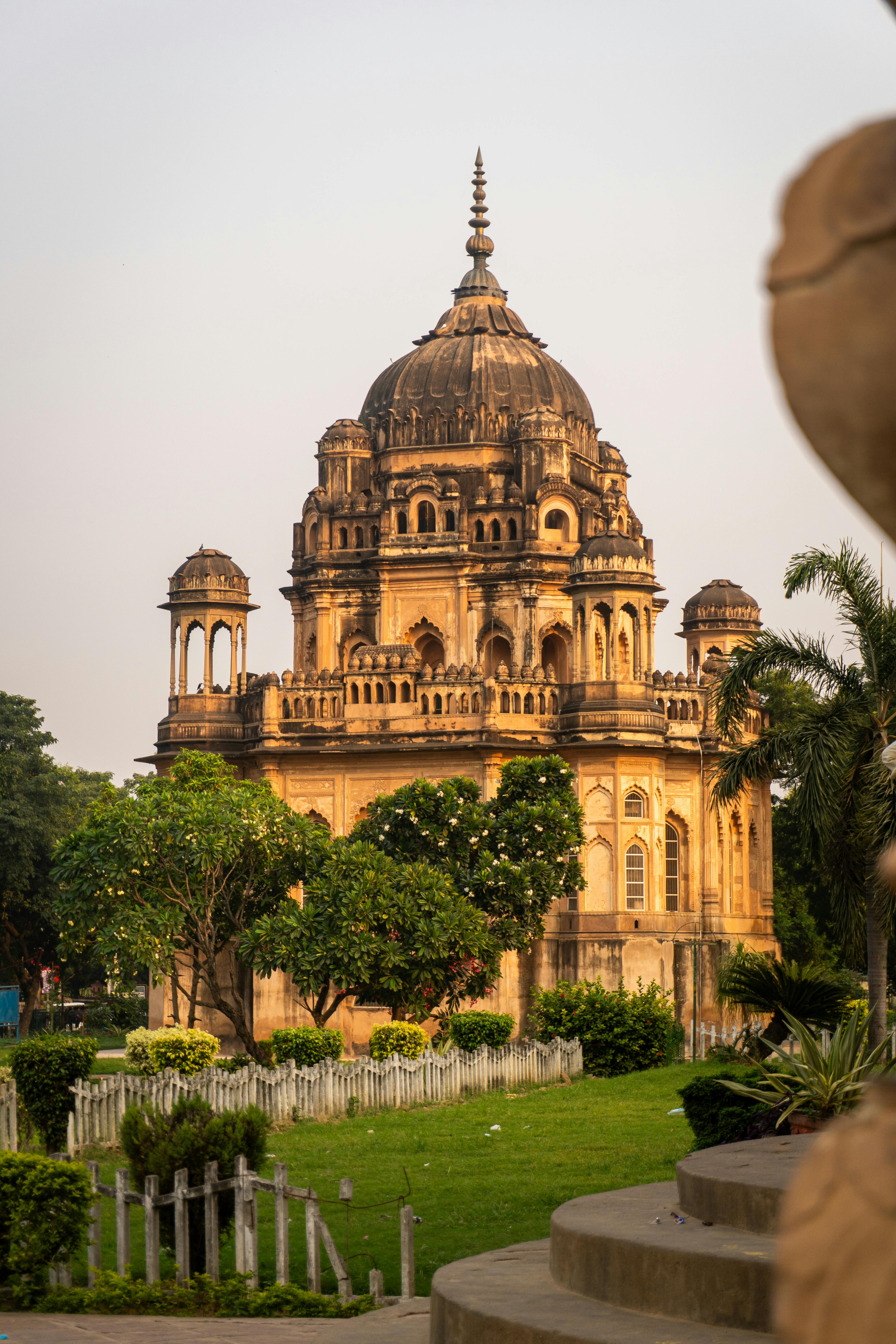 Explore the intricate architecture of Khurshid Jah's tomb amidst lush greenery in Lucknow, India.