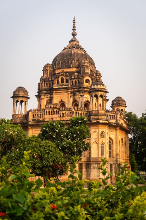 Free Stunning architectural mausoleum in Lucknow, India, surrounded by lush greenery at sunset. Stock Photo