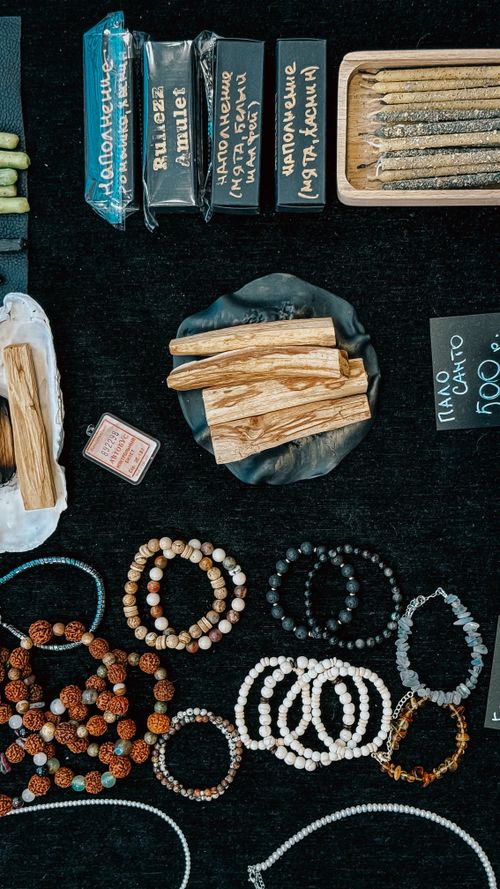 Free Unique handcrafted bracelets and incense displayed on a market table, perfect for bohemian decor. Stock Photo