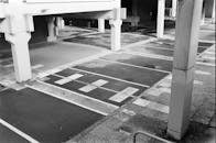 Empty urban parking lot with concrete pillars