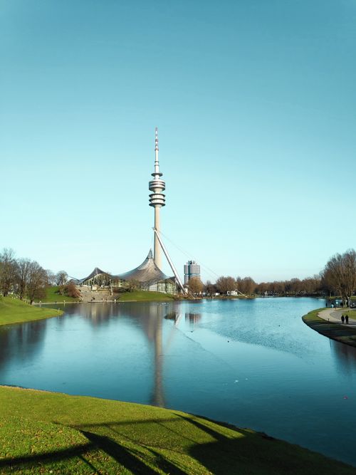 Free View of the Munich Olympic Tower and lake under a clear sky. Stock Photo