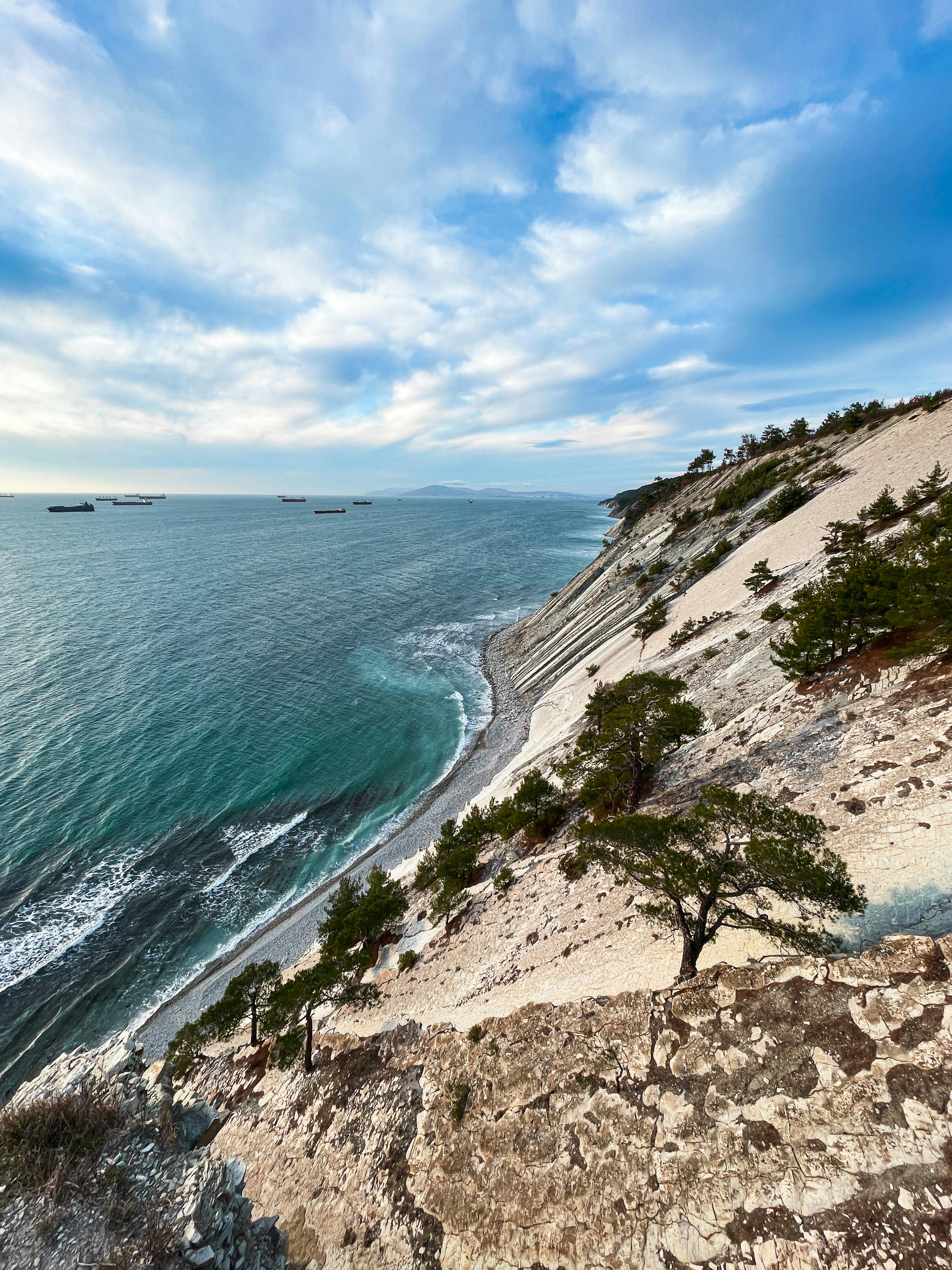 Cabopino natural beach with dramatic cliffs and pine trees overlooking the sea
