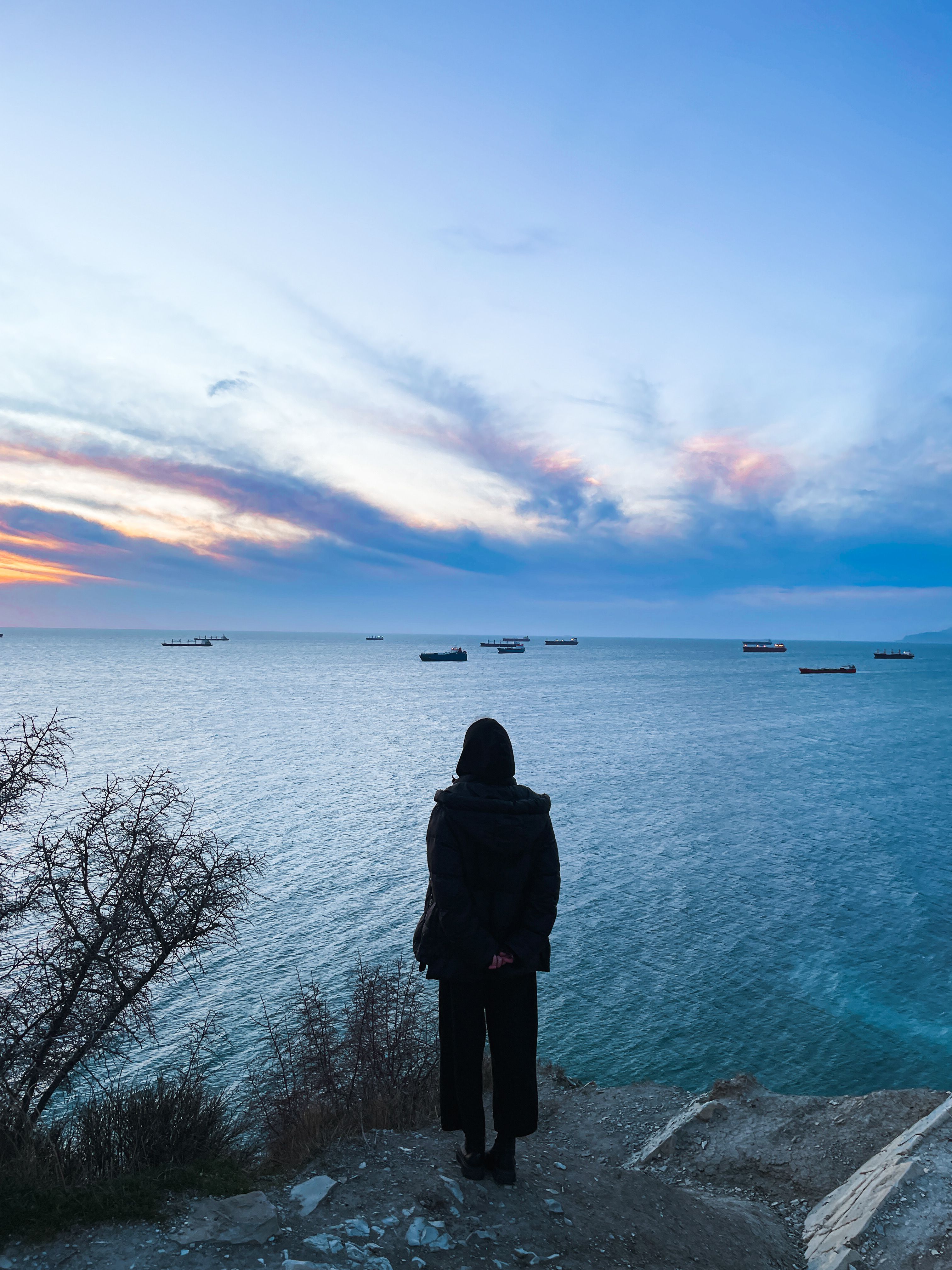 Contemplative View of the Ocean at Sunset · Free Stock Photo