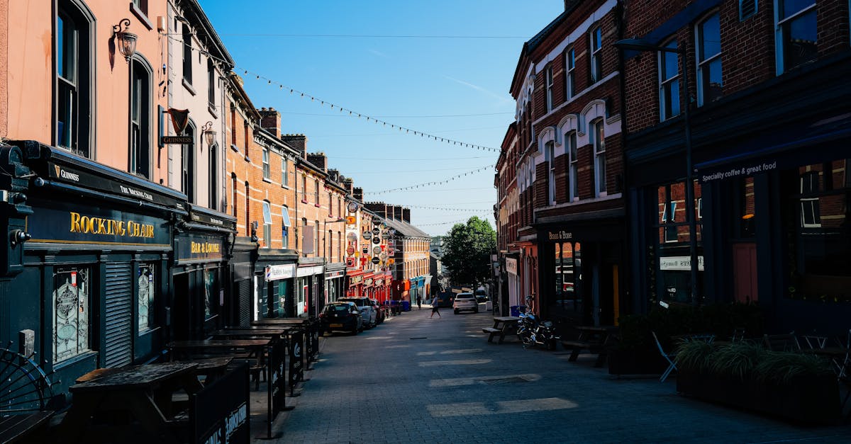 Photo by Adrien Olichon A picturesque urban street with colorful buildings under a clear blue sky.