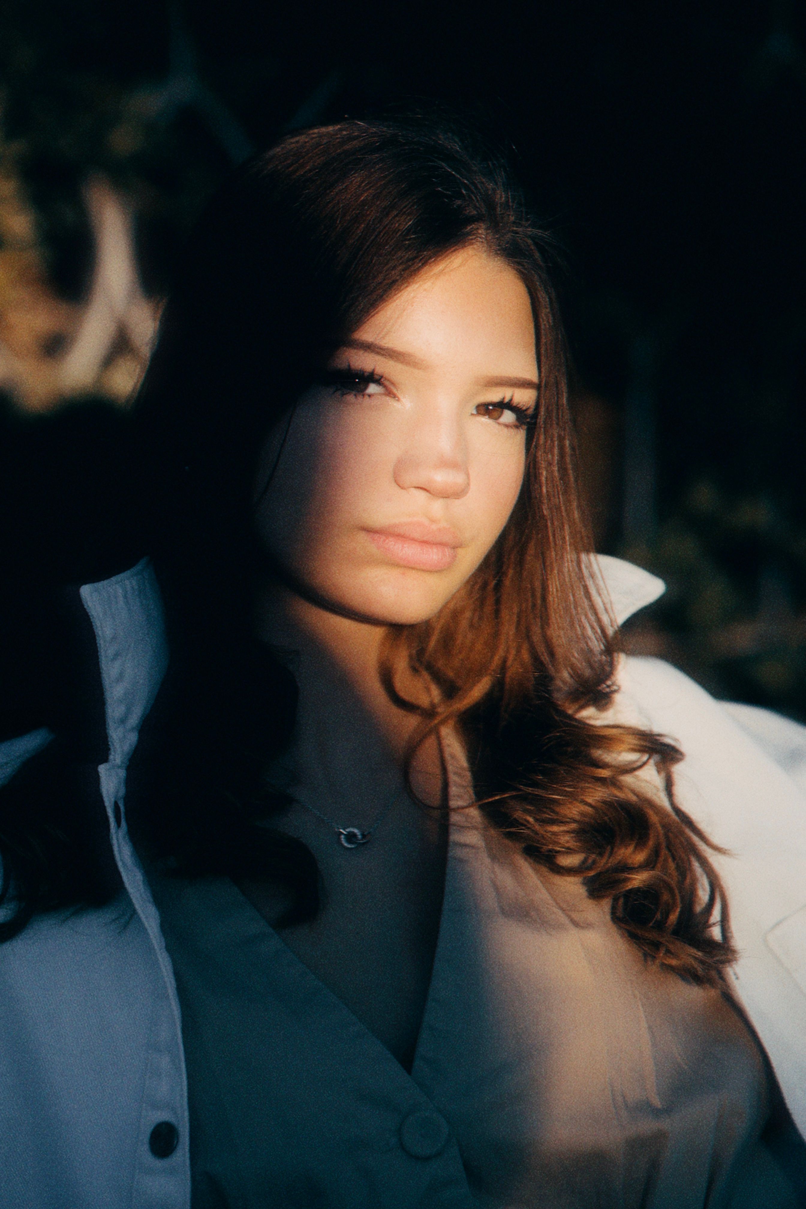 Young woman in dramatic lighting with shadows outdoors in evening.. young, woman, dramatic
