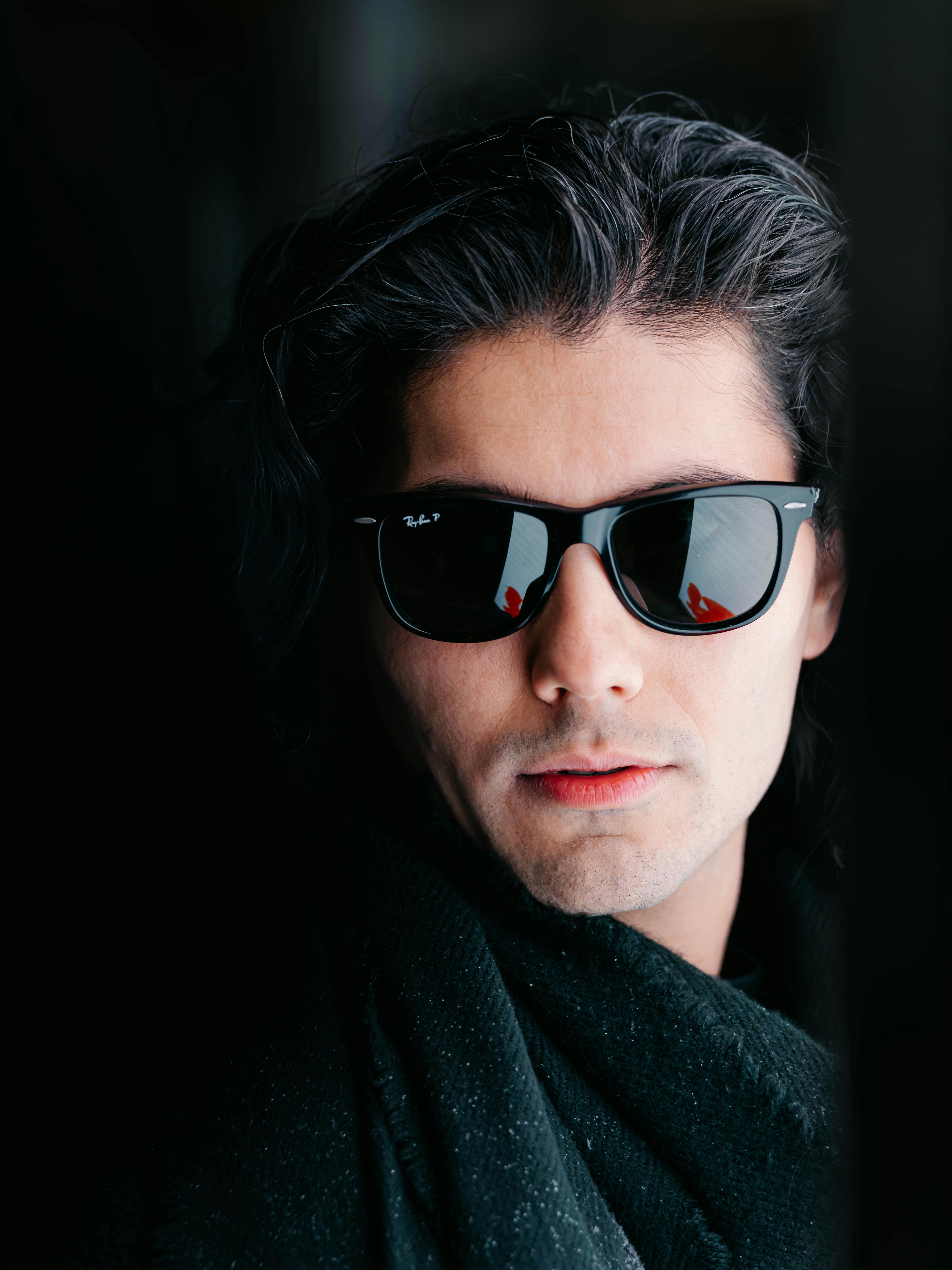 Free A fashionable male portrait with sunglasses and a dark backdrop, captured in Vienna. Stock Photo