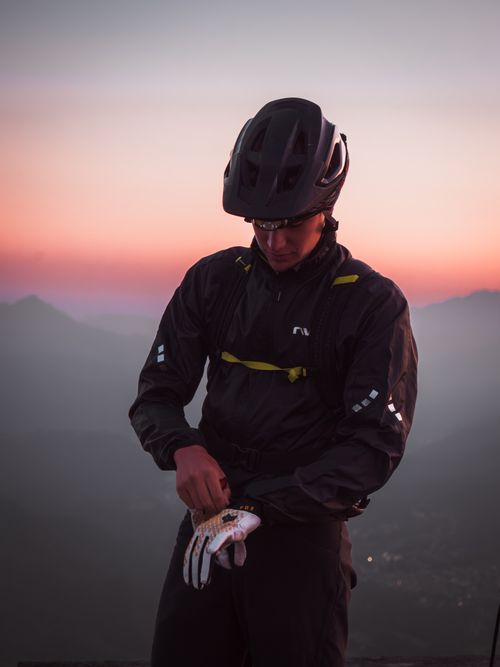 Free A mountain biker prepares for an adventure at sunset in Castione della Presolana, Italy. Stock Photo
