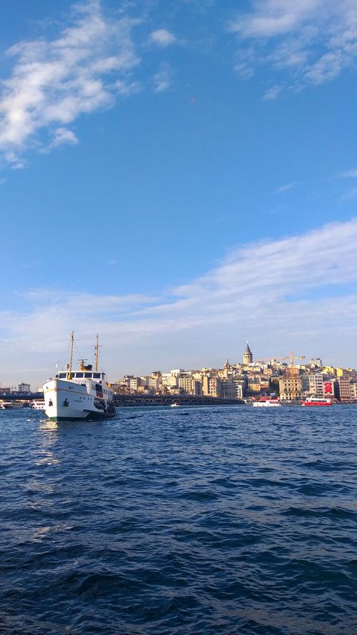 Free A sunny day in İstanbul featuring boats on the water and the city skyline with blue skies. Stock Photo
