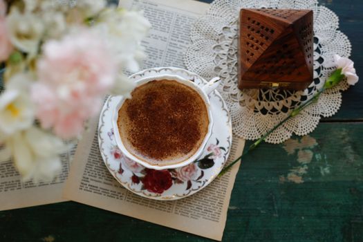 Aesthetic vintage tea setup with floral decor and rustic elements, perfect for cozy interiors.