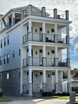 Stylish three-story building with modern architectural design and stone facade.
