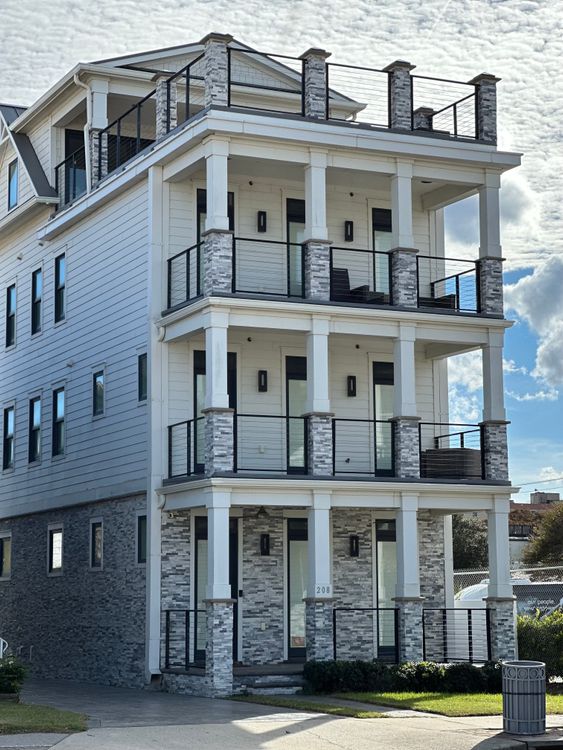 Multi Stone Building Modern Multi-Story Stone and Glass Building · Free Stock Photo