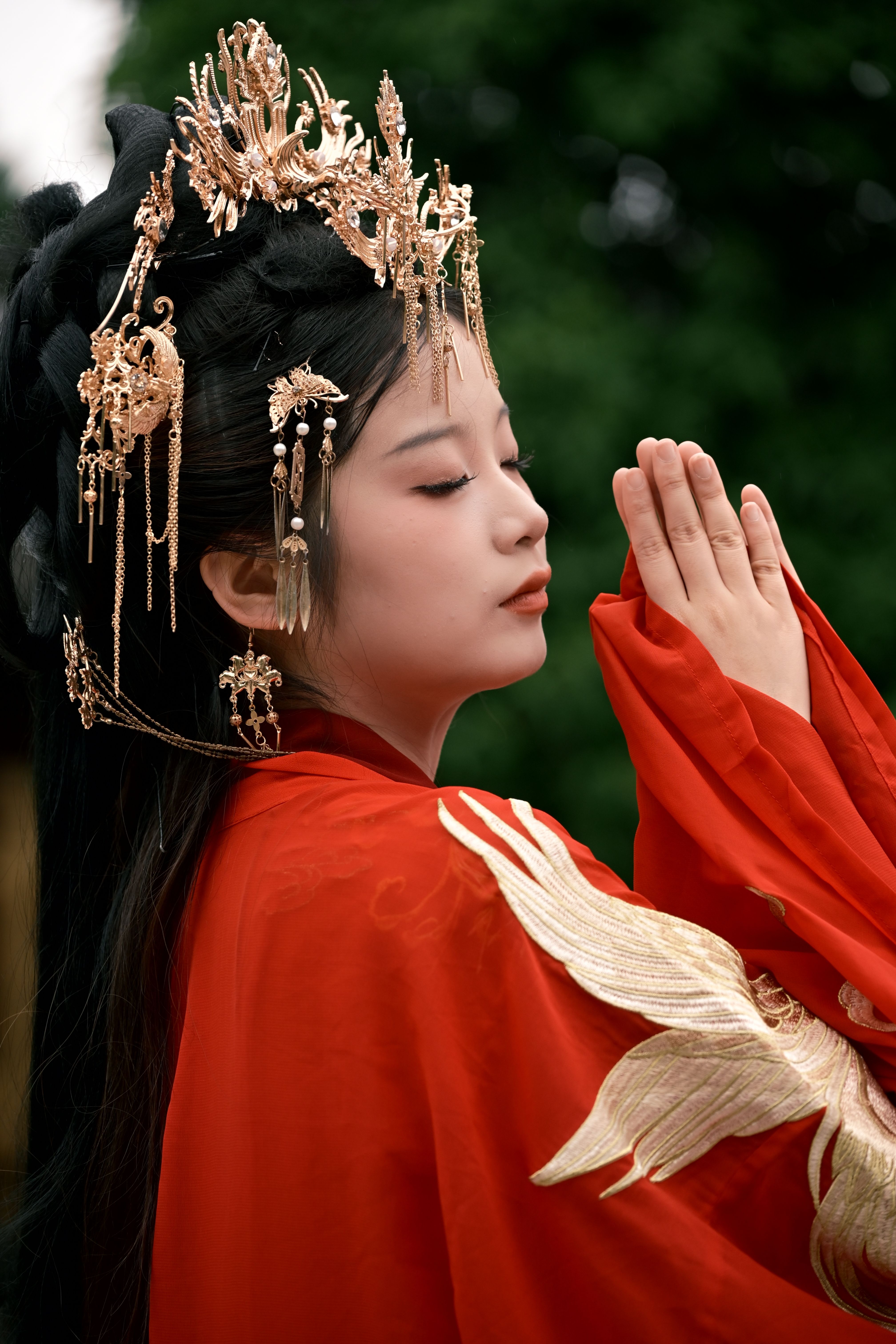 Beautiful side profile portrait of a woman in traditional red attire with ornate headpiece.