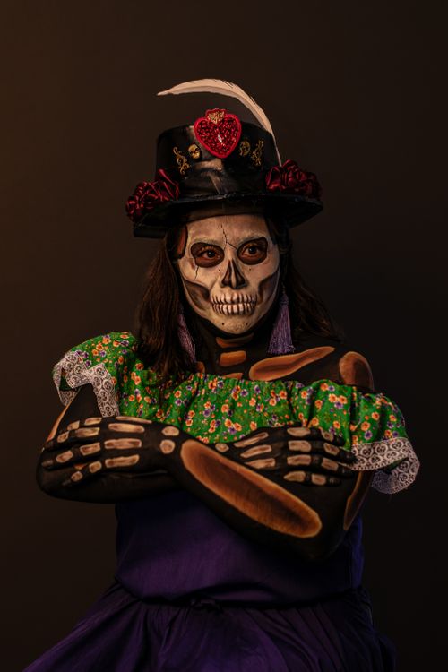 Free Vibrant skeleton costume for Day of the Dead celebrations with intricate makeup and attire. Stock Photo