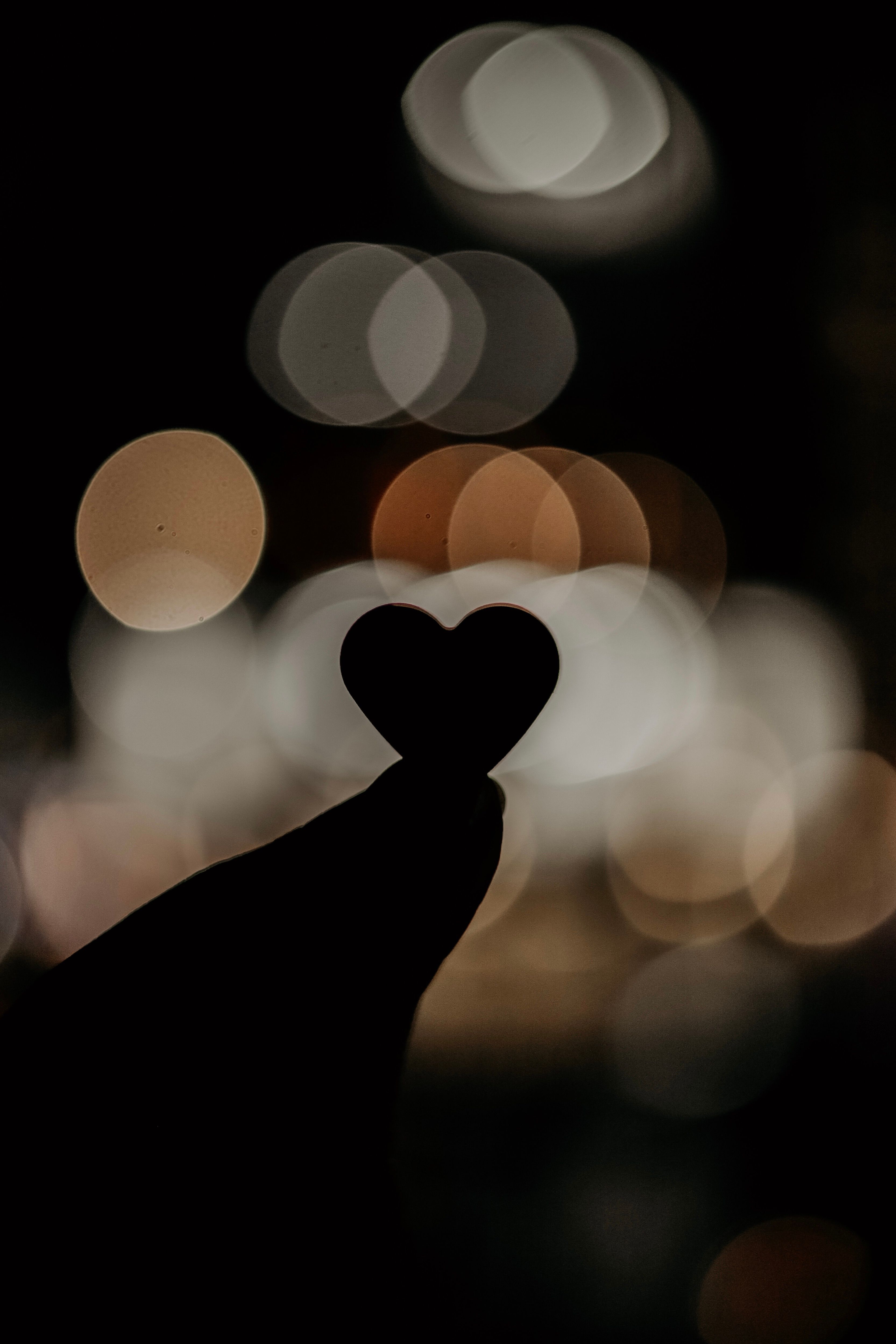 Silhouette of Heart Against Bokeh Lights · Free Stock Photo