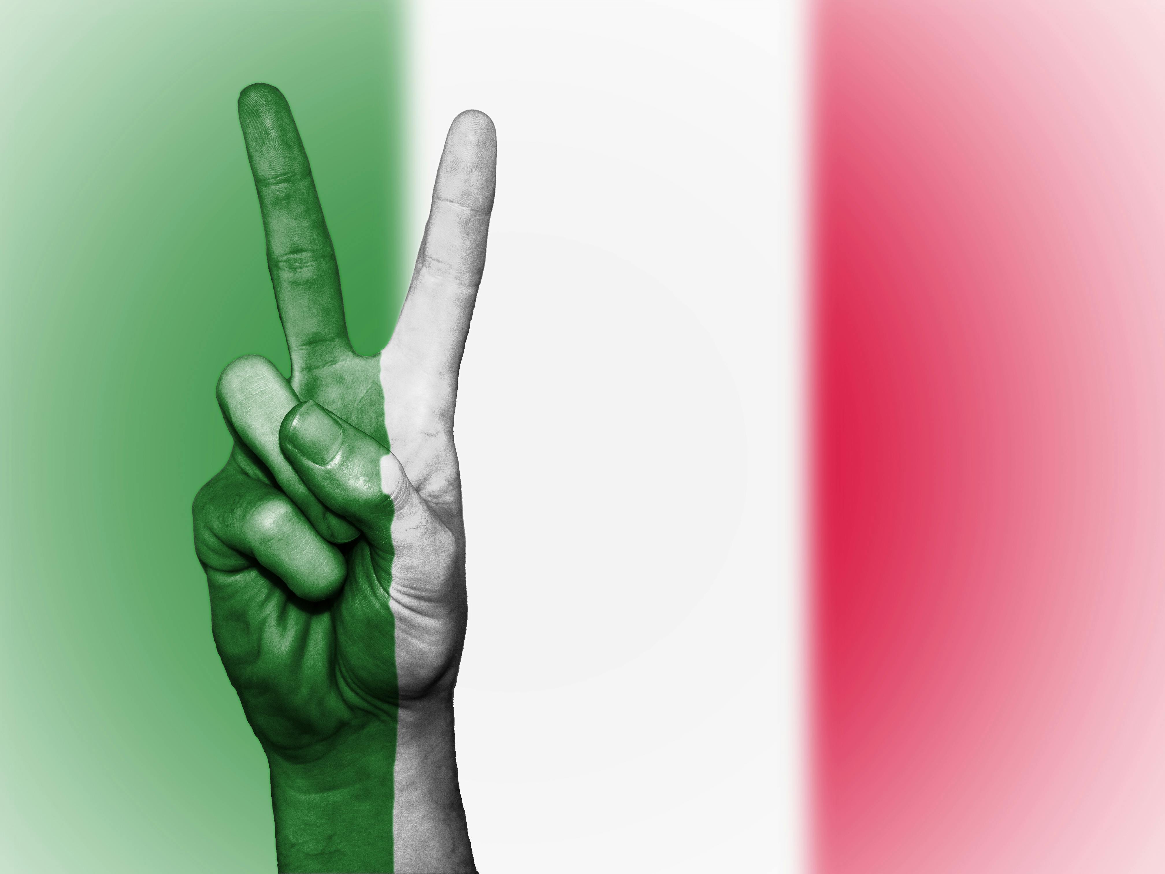 Person's Hand Doing Peace Sign With India Flag Backdrop