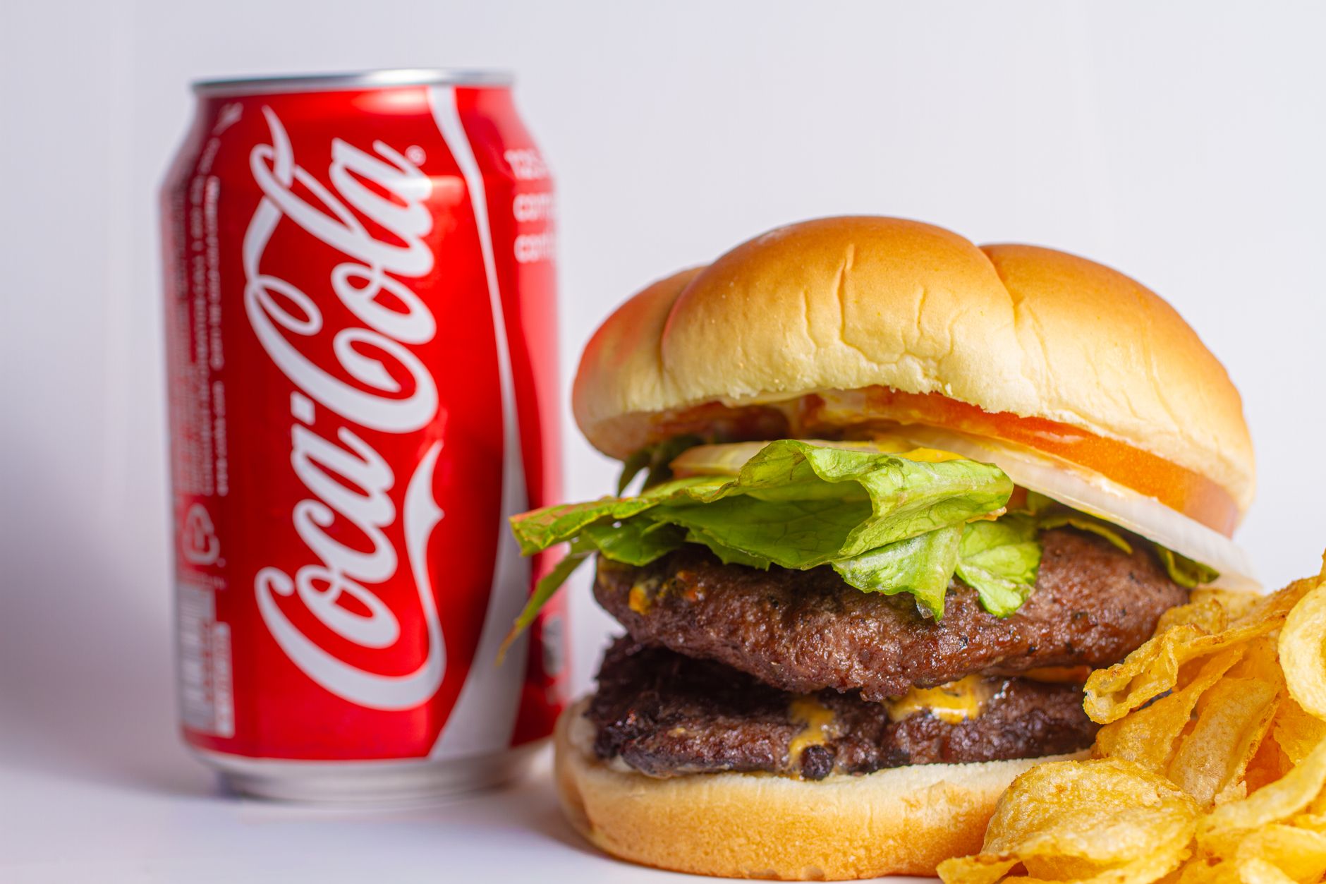 Close-up of a canned cheeseburger showing the patty, cheese, and bun inside the can