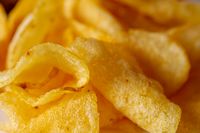 Close-up of crisp golden potato chips — photo by Caleb Oquendo on Pexels
