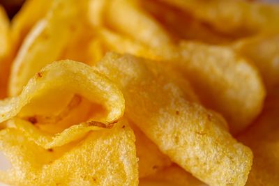 Close-up of crisp golden ridged potato chips — photo by Caleb Oquendo on Pexels
