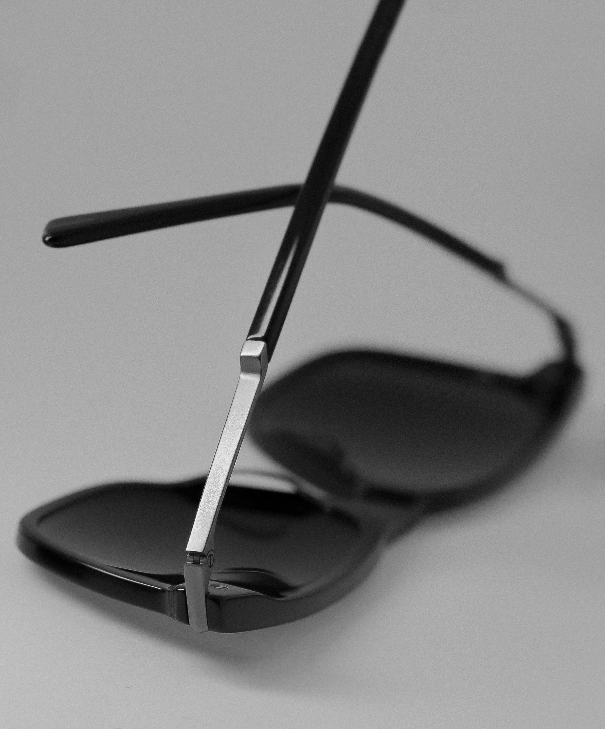 Free Stylish black sunglasses displayed on a sleek background, highlighting modern fashion. Stock Photo