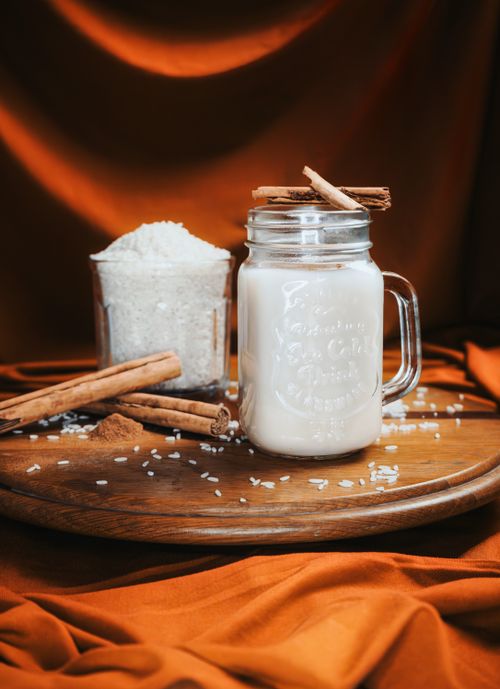 Free Cozy warm cinnamon rice milk in a jar with rustic orange ambiance. Stock Photo