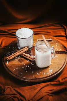 Cozy cinnamon-spiced rice beverage on a wooden platter with warm tones.
