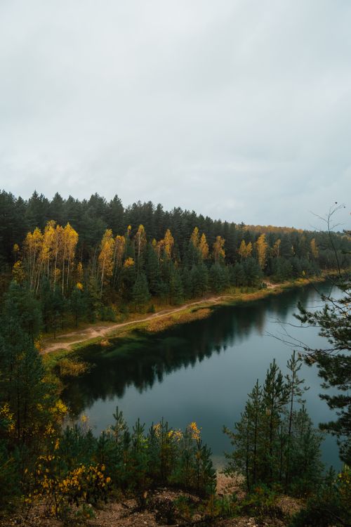 Free Beautiful autumn landscape with a forest by a calm lake. Stock Photo