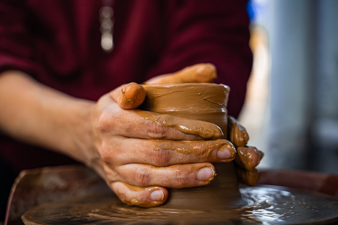 Artisan hands shaping pottery with skill