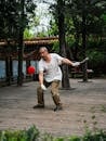 Elderly Man Practicing Diabolo in a Lush Park Setting