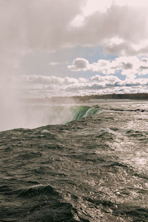 Free Breathtaking view of Niagara Falls under a cloudy sky, showcasing natural beauty. Stock Photo