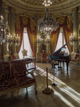 Luxurious interior of a Newport mansion with antique furnishings and a grand piano.