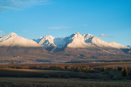 Breathtaking landscape of snow-capped High Tatras mountains during a sunny day in Slovakia., free online jigsaw puzzle on JigsawPuzzlesFreeOnline.org