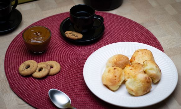 A cozy setup with coffee, pão de queijo, and dulce de leche in São Paulo.