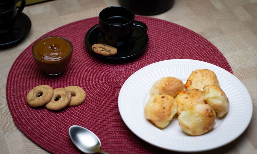 Coffee with pão de queijo and dulce de leche on a São Paulo table