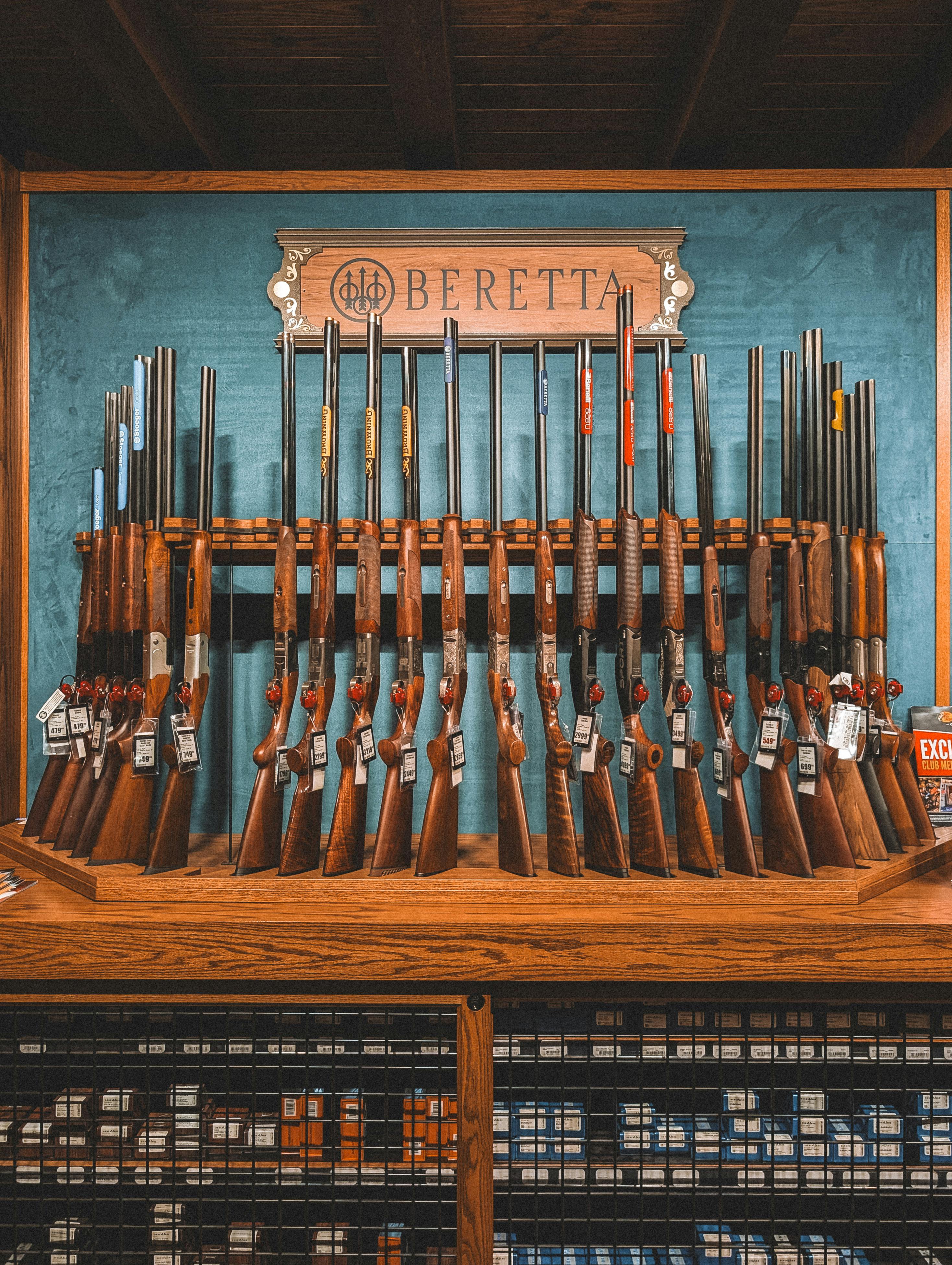 A collection of Beretta rifles displayed on a rack inside a store in St. Augustine, Florida.