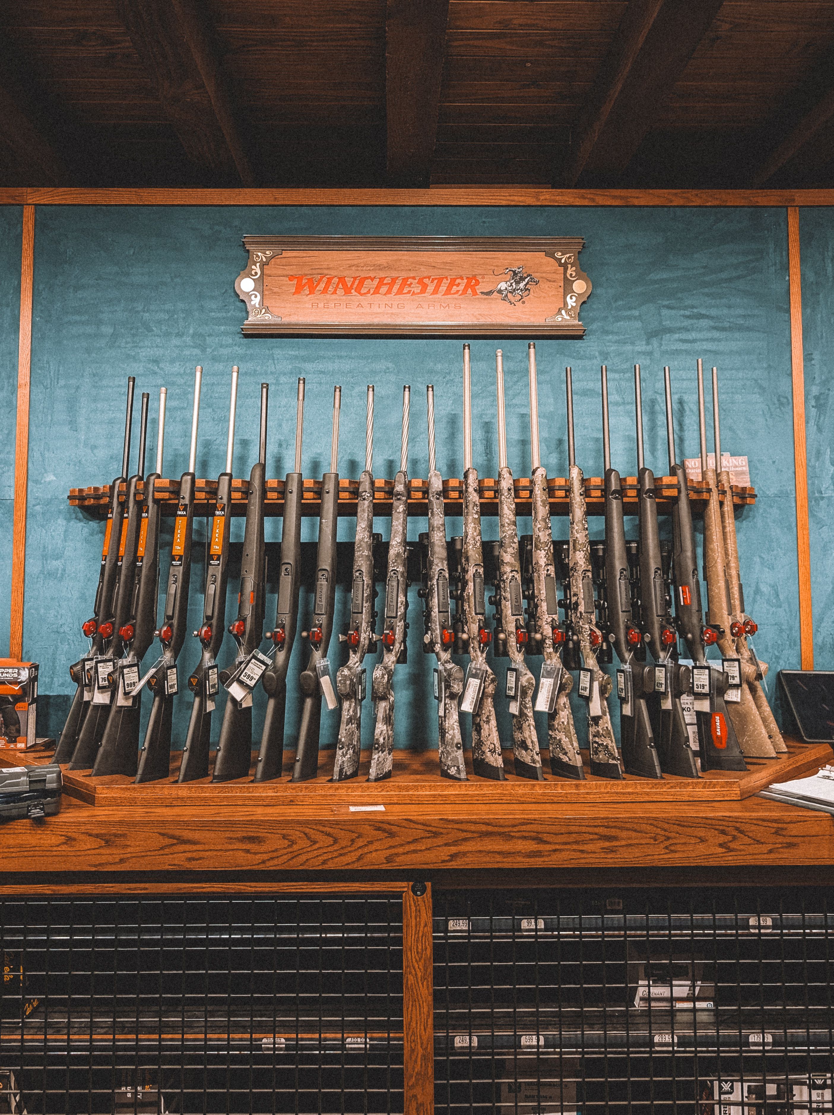 A collection of rifles neatly arranged on a rack in a Winchester store in St. Augustine, Florida.