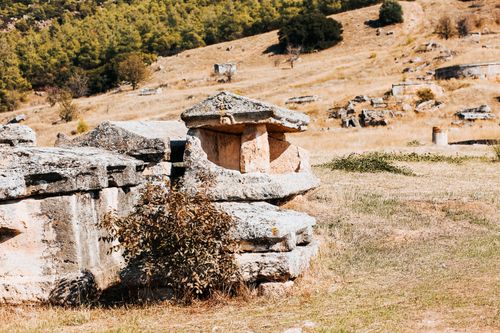 Free Explore ancient stone ruins in Hierapolis amidst a sunlit outdoor setting, embodying history. Stock Photo