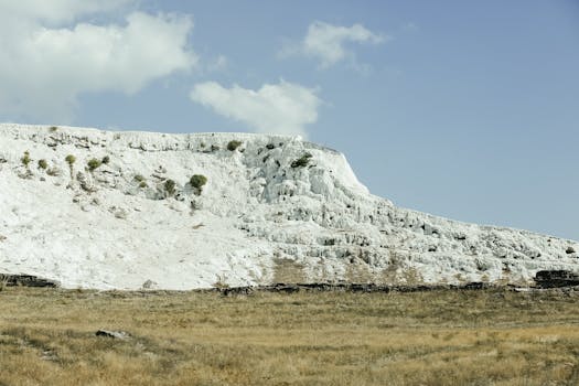 Stunning view of Pamukkale's white travertine terraces under a bright blue sky.