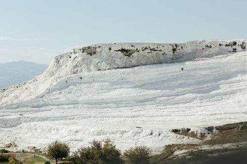 Free Breathtaking view of Pamukkale's white travertine terraces under a clear sky, capturing nature's stunning beauty. Stock Photo
