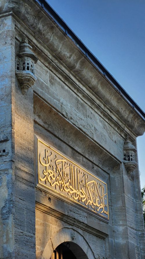 Free Detailed view of an ancient Ottoman mosque exterior in Istanbul, featuring intricate carvings and architectural beauty. Stock Photo