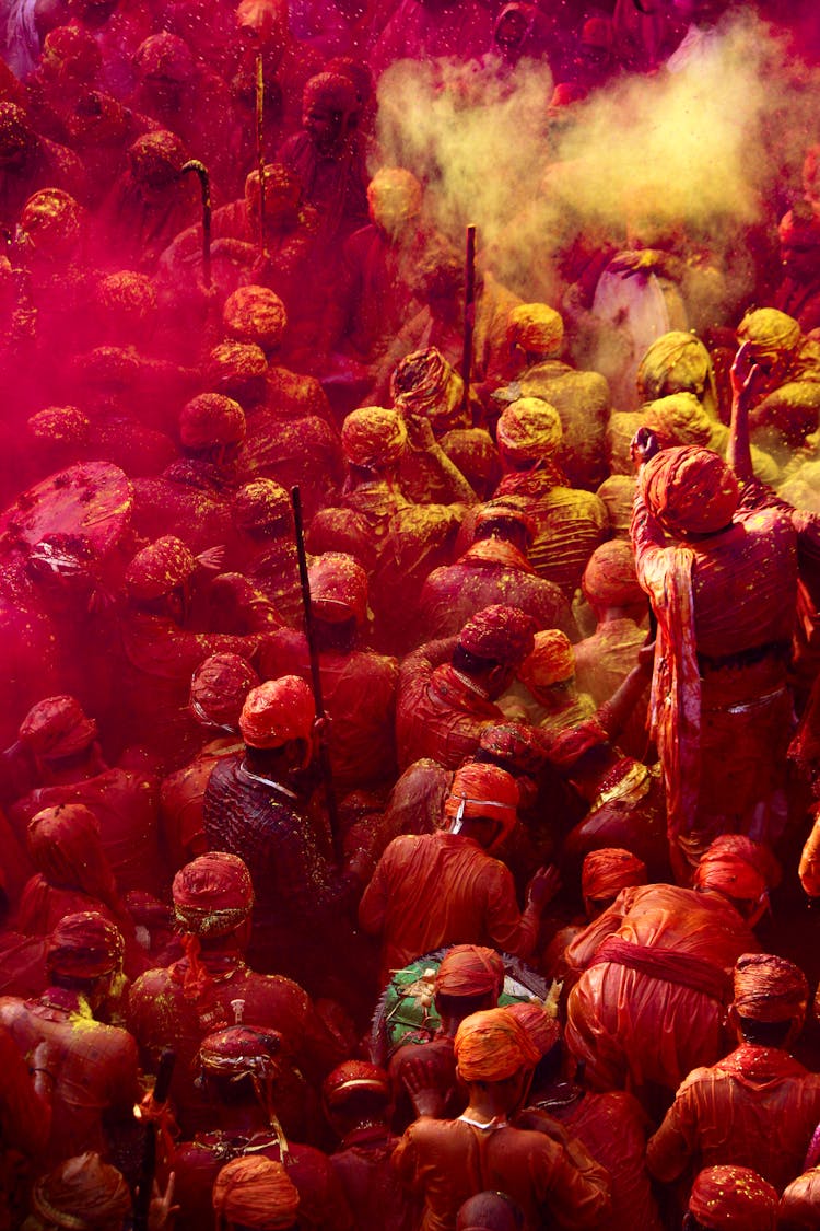 People Covered With Yellow And Pink Powder