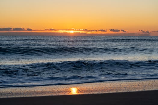 Peaceful sunrise view over the Mediterranean Sea from a Valencia beach.