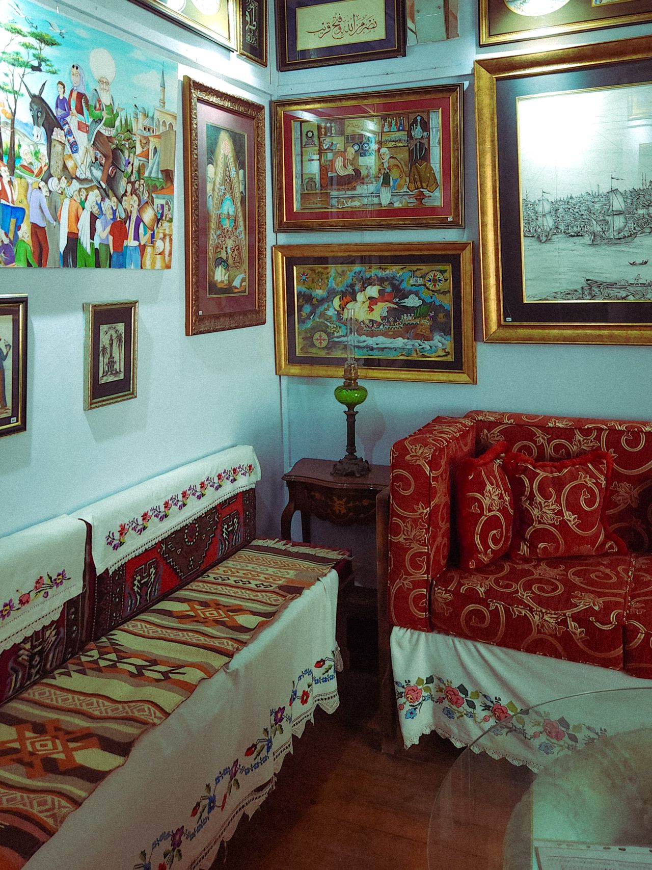 A cozy room with vintage art pieces in decorative frames